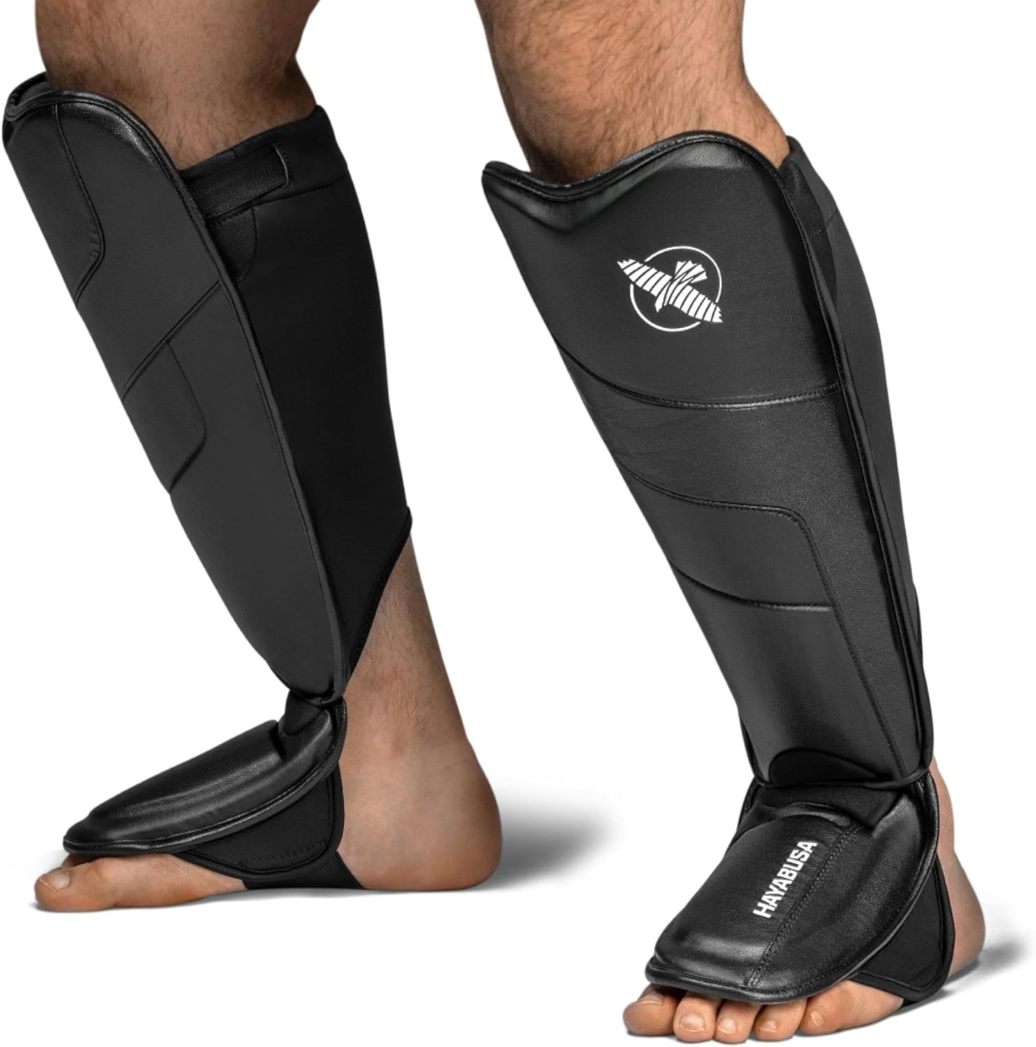 Black shin guards with a brand logo on a white background