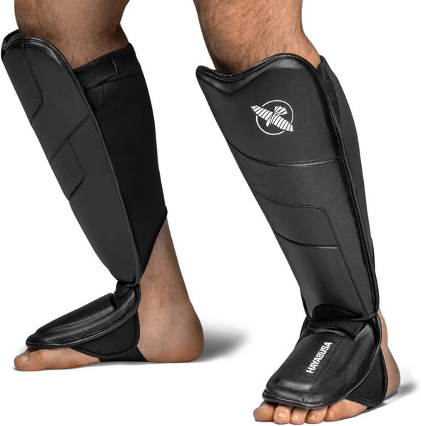 Black shin guards with a brand logo on a white background