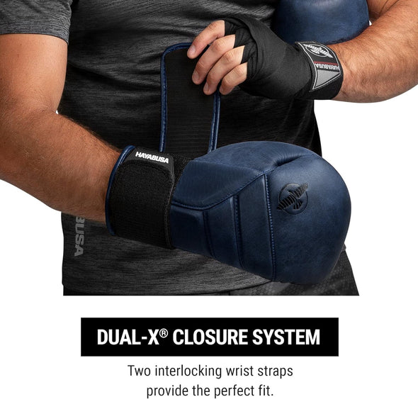 Person wearing boxing gloves with a focus on the dual-X closure system.