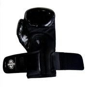 A single black martial arts guard or thumb guard with a hook-and-loop strap closure, shown against a plain white background.