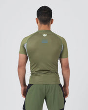 Person wearing a green athletic outfit on a white background
