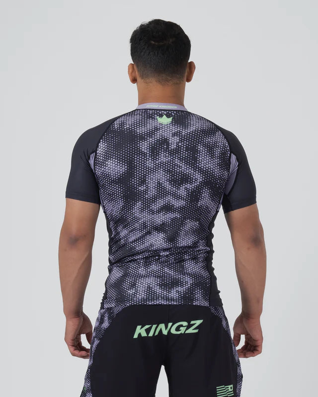 Person wearing a black and gray patterned sports outfit with 'KINGZ' branding on a white background