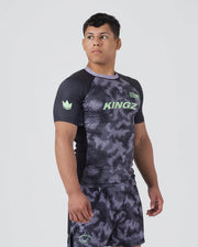 Person wearing a black and gray patterned sports outfit with 'KINGZ' branding on a white background