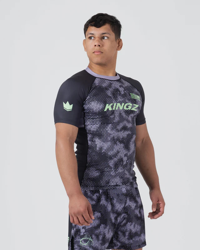 Person wearing a black and gray patterned sports outfit with 'KINGZ' branding on a white background