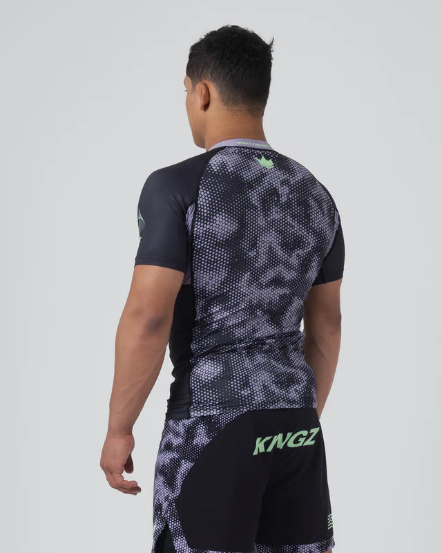 Person wearing a black and gray patterned athletic outfit with 'KINGZ' branding on a white background
