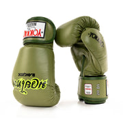 Pair of green boxing gloves with visible branding on a white background