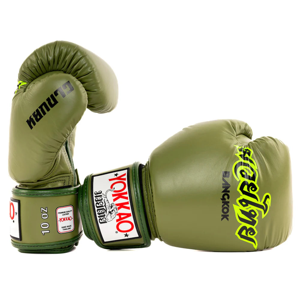 Pair of green boxing gloves with visible branding on a white background