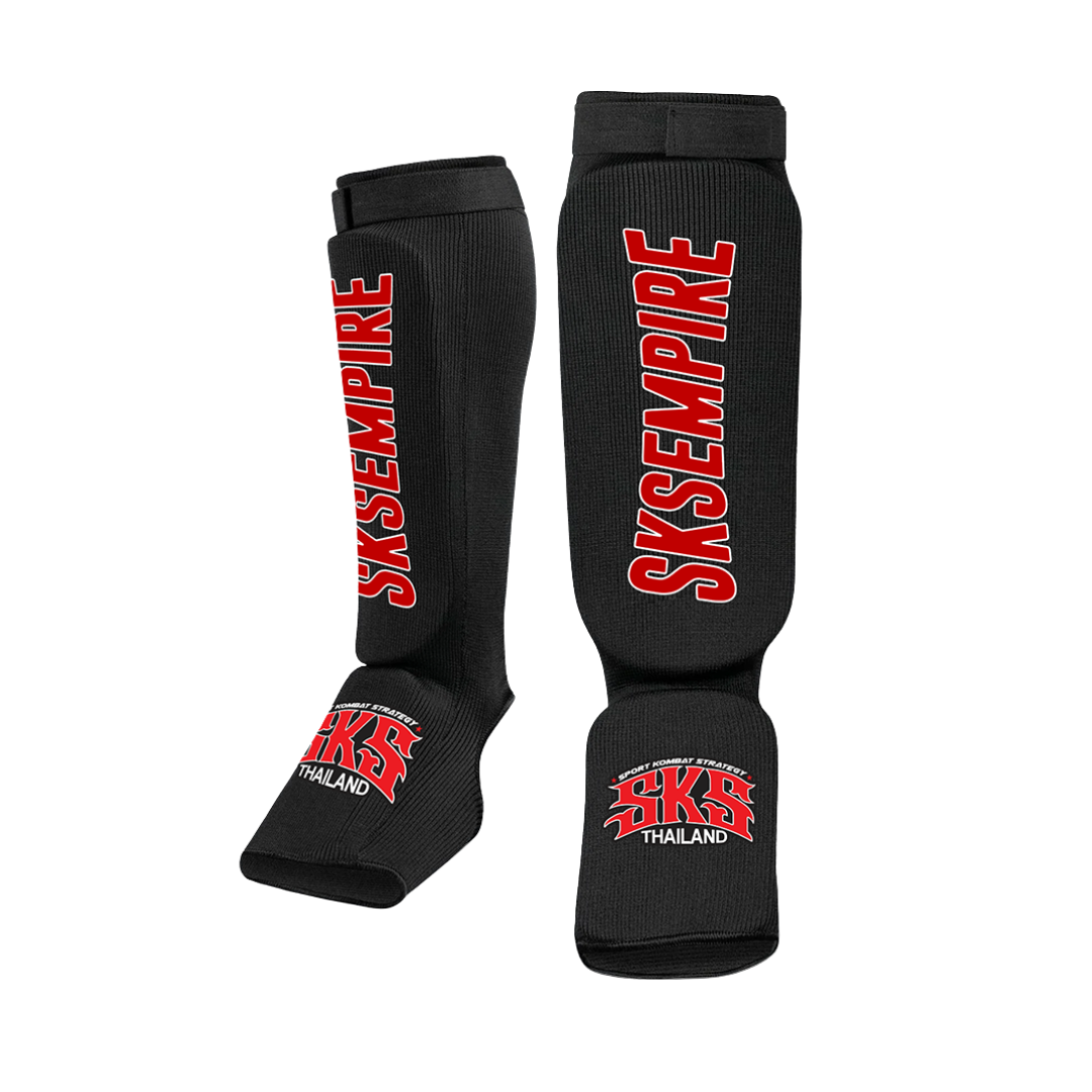 Black shin guards with red 'SKS Empire' branding on a white background