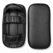 Black leather martial arts striking pads shown from two angles: one with straps and handle, and one flat rectangular pad, on a white background.