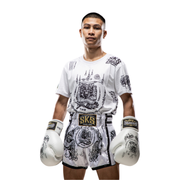 Person wearing a white boxing outfit with black designs and 'SKS' branding on a white background