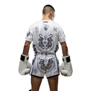 Person wearing a white martial arts uniform with black designs on a white background