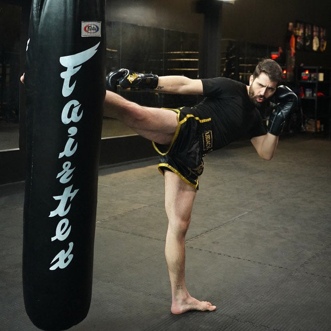 Legacy Golden Era Muay Thai shorts with traditional Thai boxing cut and gold embroidered design