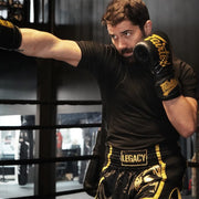Legacy Golden Era Muay Thai shorts with traditional Thai boxing cut and gold embroidered design