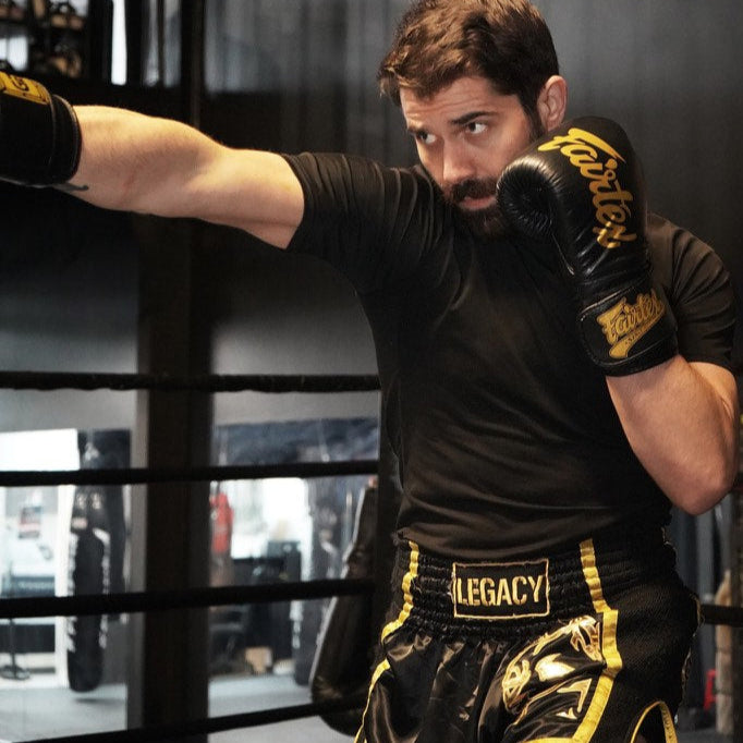 Legacy Golden Era Muay Thai shorts with traditional Thai boxing cut and gold embroidered design