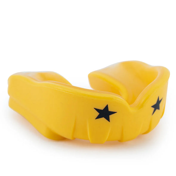 Yellow mouthguard with black stars on a white background