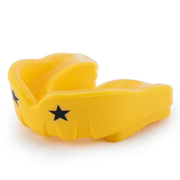Yellow mouthguard with black star design on a white background