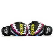 Pair of black boxing gloves with colorful shark design and 'Yokkao' branding on a white background.