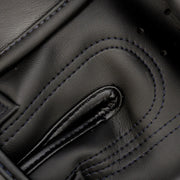 Close-up of a black leather glove with stitching details