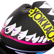 Black boxing glove with colorful designs and 'Yokkao' branding on a white background