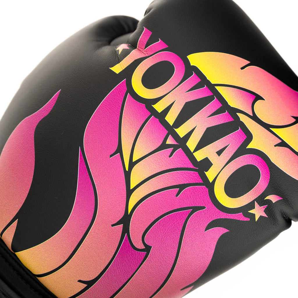 Black boxing glove with pink and yellow flames and 'YOKKAO' branding.