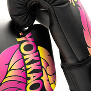 Black boxing glove with colorful YOKKAO branding on a white background