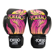 Pair of Yokkao boxing gloves with colorful flame design on a white background