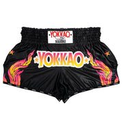 Black shorts with colorful 'YOKKAO' branding on a white background