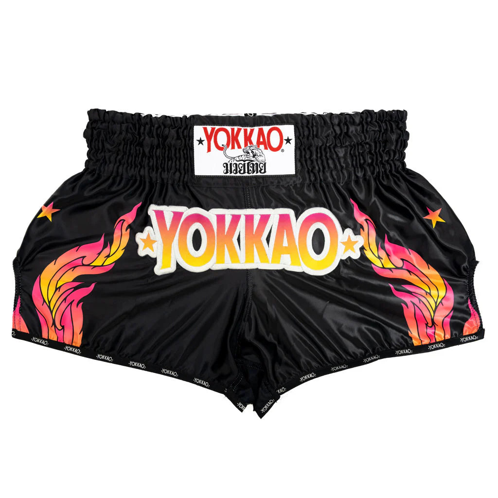 Black shorts with colorful 'YOKKAO' branding on a white background