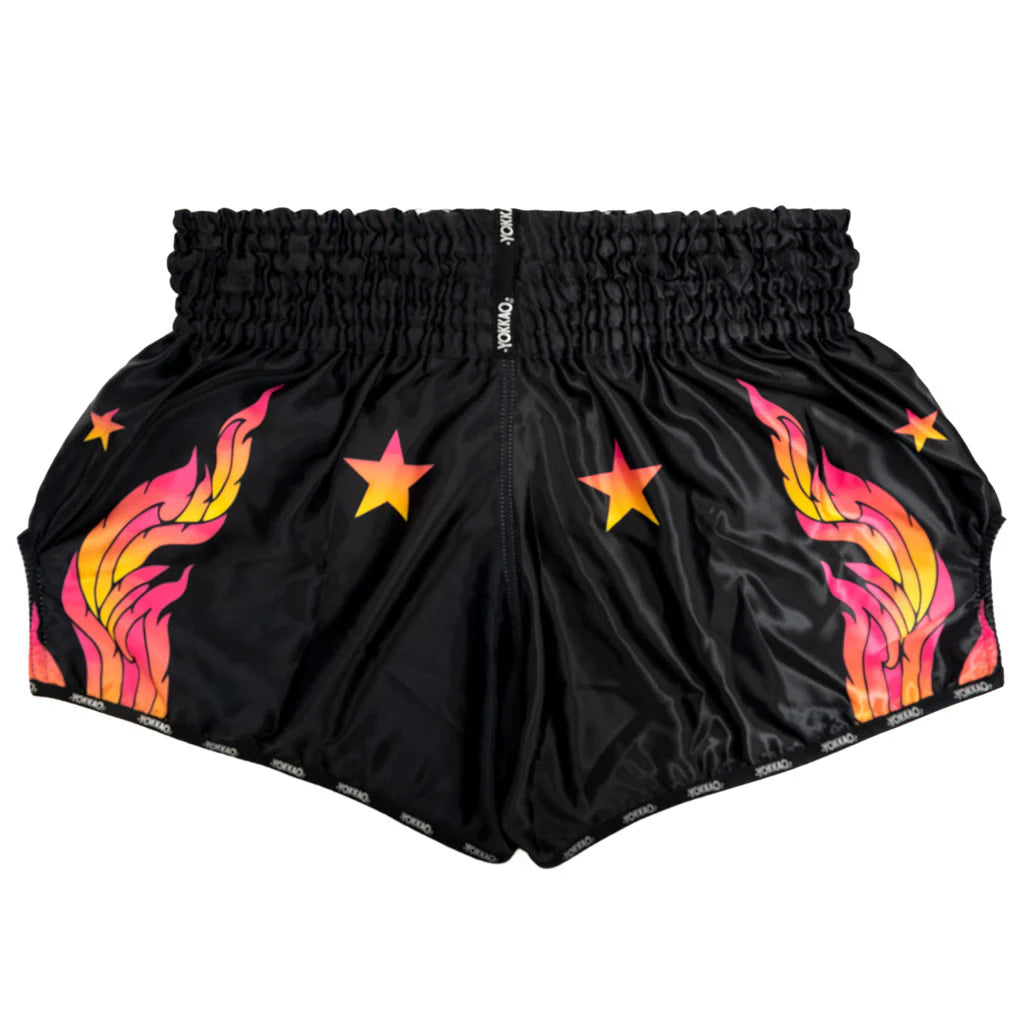 Black shorts with colorful flame and star designs on a white background