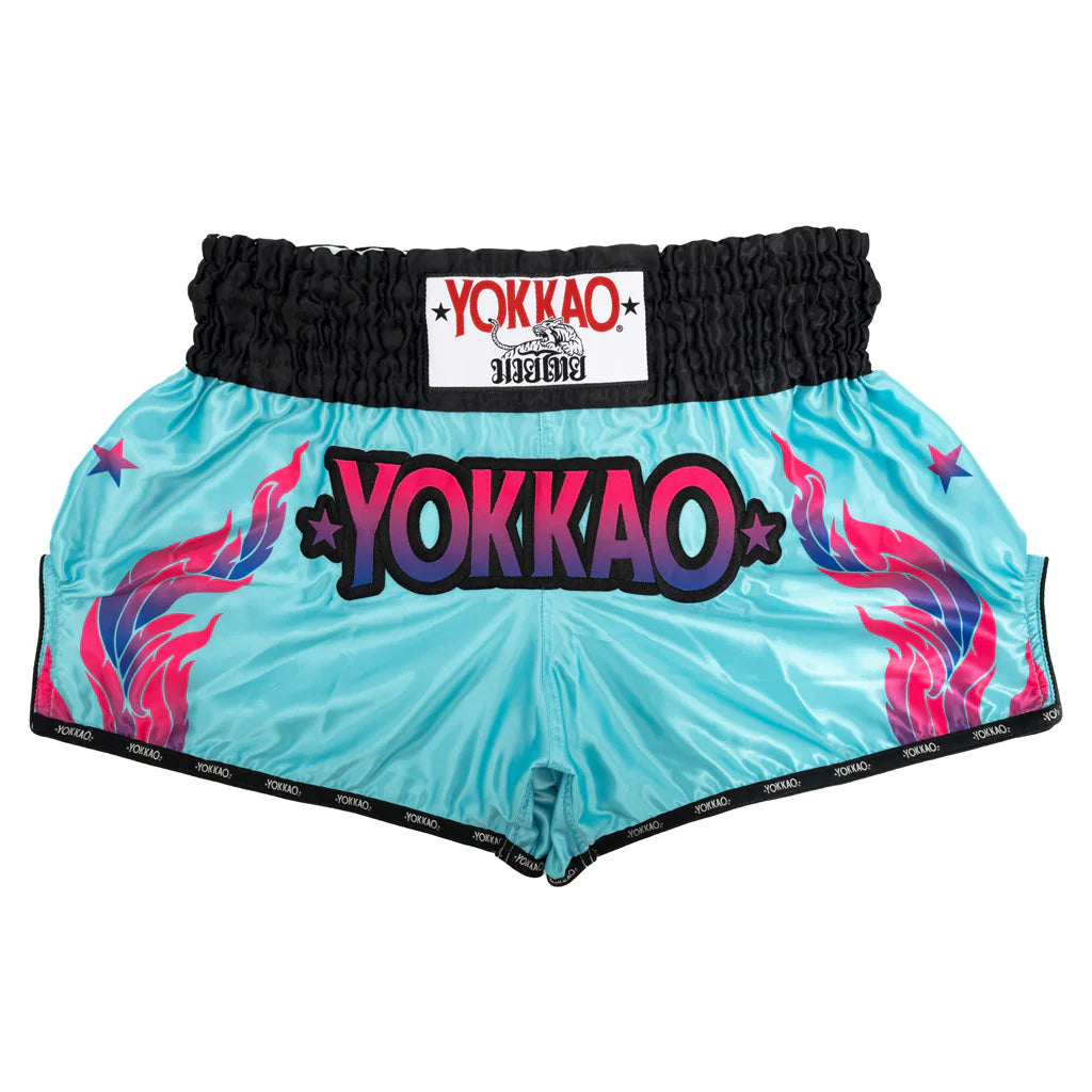 Turquoise boxing shorts with colorful flames and Yokkao branding on a white background
