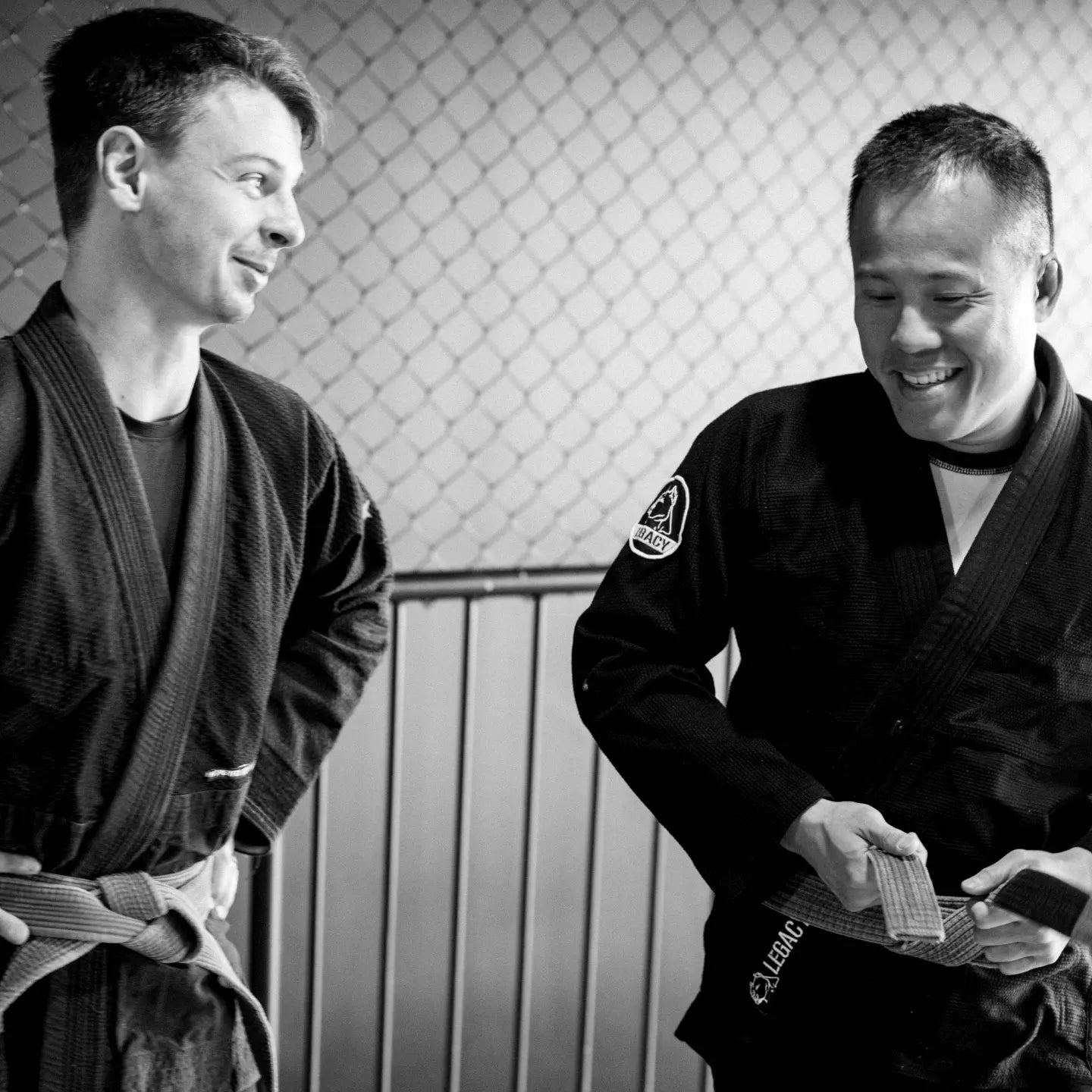 Official Team Legacy BJJ Gi in black, featuring a 450 GSM Pearl Weave Plus jacket, 10 oz cotton drill pants, reinforced stitching, and includes a white belt and drawstring bag.