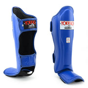 Blue shin guards with Yokkao branding on a white background