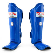Pair of blue shin guards with Yokkao branding on a white background