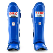 Pair of blue shin guards with Yokkao branding on a white background