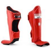 Red shin guards with black soles on a white background, featuring the Yokkao brand.