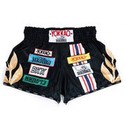 Black boxing shorts with colorful branding on a white background