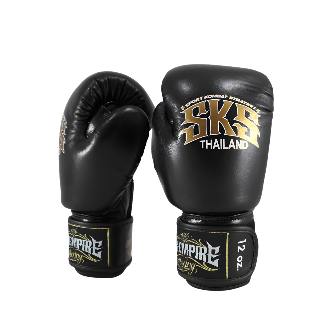 Black boxing gloves with gold branding on a white background