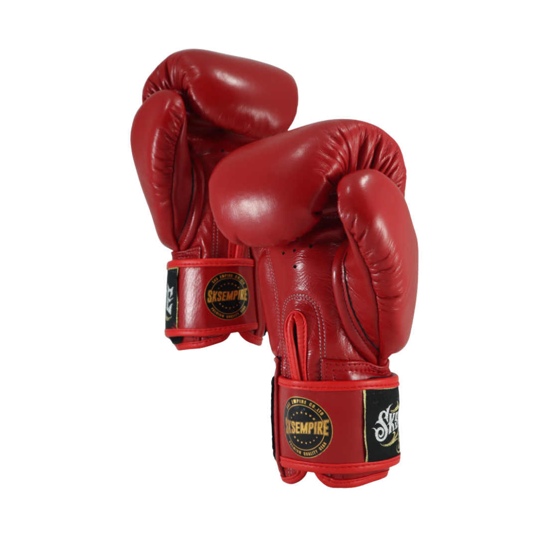 Red boxing gloves with a brand logo on a white background