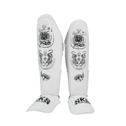White shin guards with black designs and branding on a white background