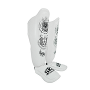 White shin guards with black patterns and branding on a white background