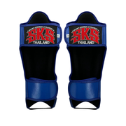 Pair of blue and black shin guards with SKS Thailand branding on a white background