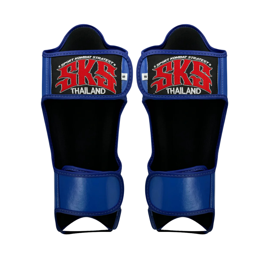 Pair of blue and black shin guards with SKS Thailand branding on a white background