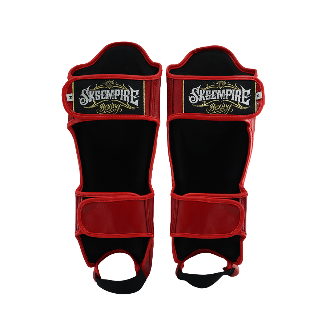 Red and black shin guards with Skeempire branding on a white background