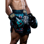 Person wearing SKS Empire boxing shorts and gloves on a white background