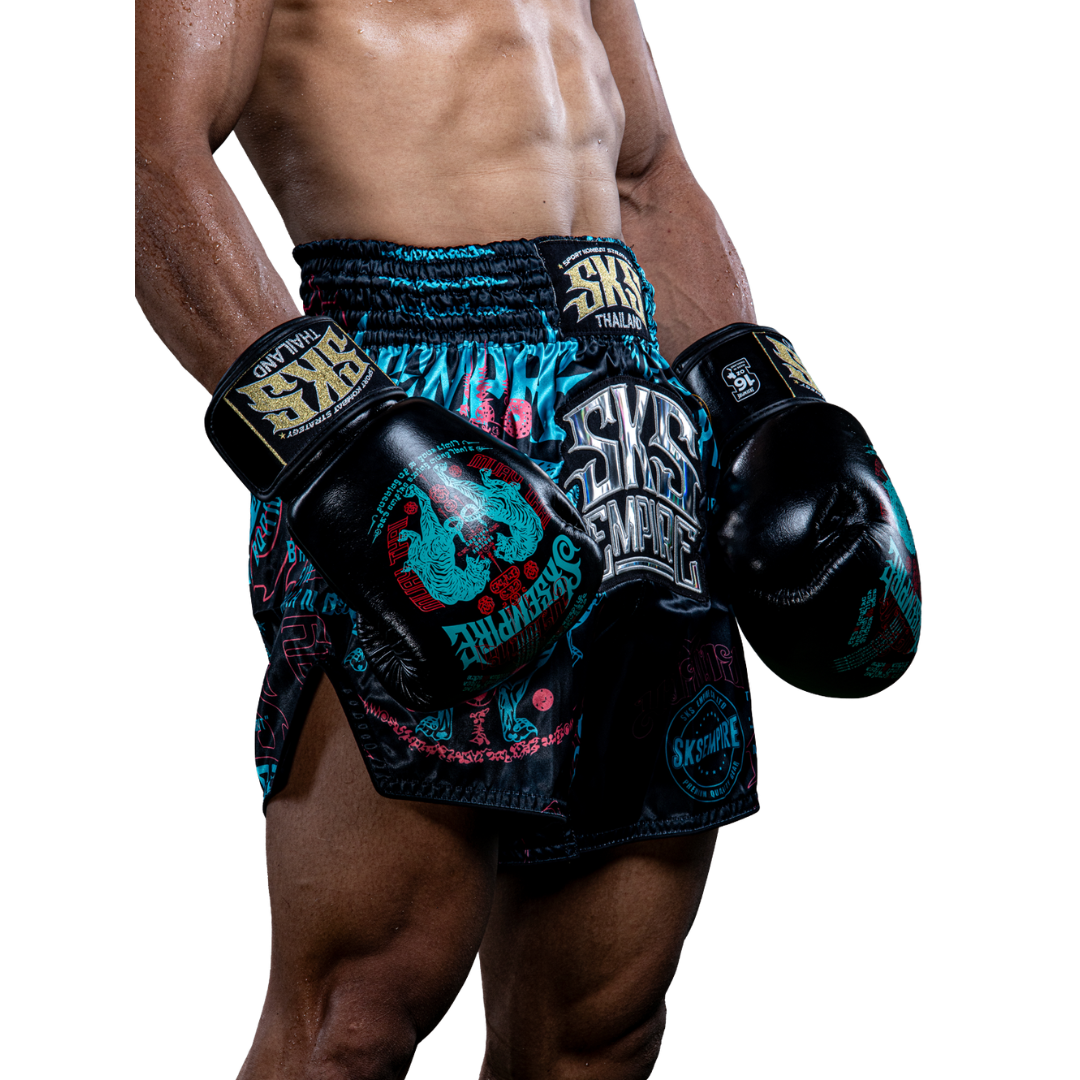 Person wearing SKS Empire boxing shorts and gloves on a white background