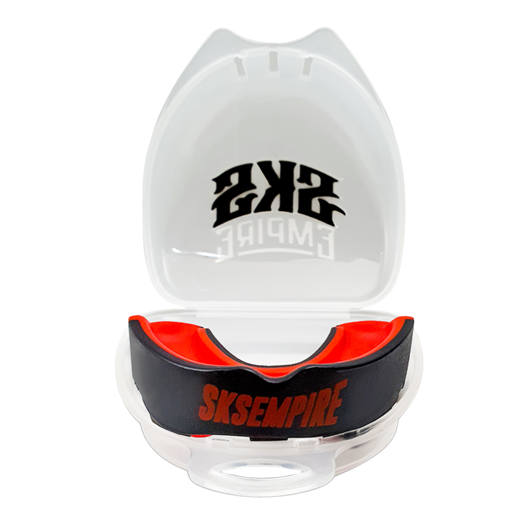 Black and red mouthguard in a clear case with 'SKS Empire' branding on a white background
