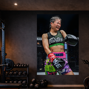 MMA fighter in a gym setting with training equipment.