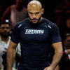 Person wearing a dark blue 'Tatami Fightwear' shirt in a blurred crowd setting