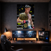 Gaming setup with a large monitor displaying a boxing match, surrounded by gaming accessories.