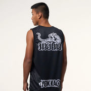 Person wearing a black sleeveless shirt with a white tiger logo and 'YOKKAO' branding on the back.